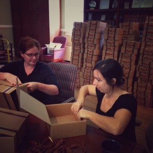 Margaret Gaffney and Abby Huggins prepare suitcase-inspired lunch boxes for the SFA symposium