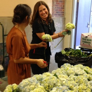 SST grad students Abby Huggins and Kate Wiggins arrange flower displays for the SFA symposium