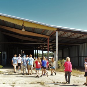 Students head inside an old cotton gin, followed by Dr. McKee and Rebecca Cleary