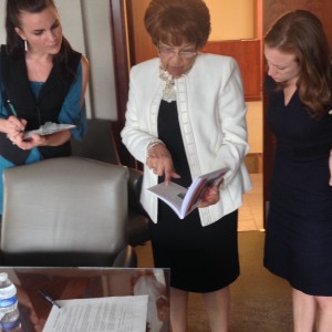 Interviewee and movement veteran Flonzie Brown-Wright shows MDAH's Leandra Straka-Orr and Becca her memoir.