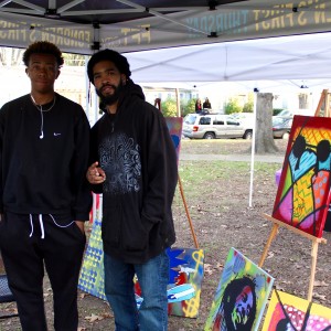 Local visual artist Steve Hendrix (right) showing his work at 3rd Eye Music Festival.