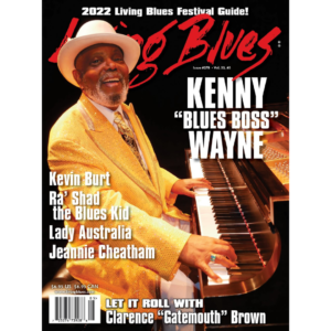 Kenny Wayne wearing yellow suit playing piano