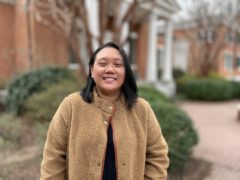 Melanie Ho wears a brown sweater