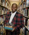 Jalon poses in a library while holding books