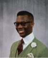 Xavier Sivels in a green suit with a flower in the lapel