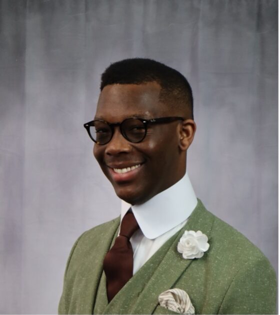 Xavier Sivels in a green suit with a flower in the lapel