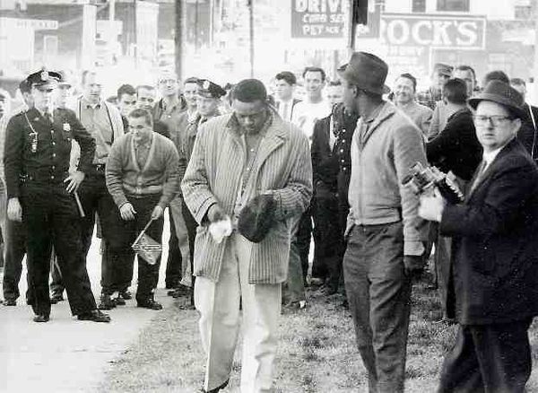 Protester Bunt gill wiping his hat after being hit by an egg during a 1960 protest in Rock Hill. (Rock Hill Herald)